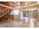Open concept living area with wood walls, laminate flooring, a modern light fixture, and natural light at 4801 Lynn Oaks Cir, Dover, FL 33527