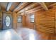 Inviting living room showcasing wood walls, wood flooring, a modern light fixture, and natural light at 4801 Lynn Oaks Cir, Dover, FL 33527