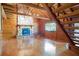 Spacious living room featuring hardwood floors, stone fireplace, and log beam construction at 4801 Lynn Oaks Cir, Dover, FL 33527