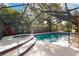 Screened pool with spa, features blue tile and relaxing patio space at 4801 Lynn Oaks Cir, Dover, FL 33527