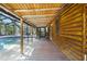 Covered walkway leading to a screened pool with a wooden beam ceiling at 4801 Lynn Oaks Cir, Dover, FL 33527