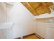 Walk-in closet featuring wood floors, shelving, and exposed wood beam ceiling at 4801 Lynn Oaks Cir, Dover, FL 33527