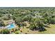 A wide aerial view shows a community pool, a playground, and tennis courts at 486 Lakeview Dr # 54, Palm Harbor, FL 34683