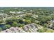 An aerial view of the community featuring mature trees, a serene pond, and well-maintained townhome exteriors at 486 Lakeview Dr # 54, Palm Harbor, FL 34683