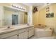 Bright bathroom offers double sinks, soaking tub, and updated fixtures at 486 Lakeview Dr # 54, Palm Harbor, FL 34683
