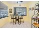 Bright breakfast nook with glass table set offers views of the yard and community lake at 486 Lakeview Dr # 54, Palm Harbor, FL 34683