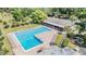 Aerial shot of a bright blue community pool with a clubhouse and lots of lounge chairs at 486 Lakeview Dr # 54, Palm Harbor, FL 34683