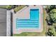 An aerial view of a large community pool with lounge chairs lining the deck at 486 Lakeview Dr # 54, Palm Harbor, FL 34683