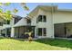 Exterior home view with screened patio, bay window, and lush yard at 486 Lakeview Dr # 54, Palm Harbor, FL 34683