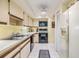 Efficient kitchen featuring white cabinets and essential appliances at 486 Lakeview Dr # 54, Palm Harbor, FL 34683