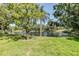 Scenic view of a tranquil pond surrounded by lush greenery and mature trees, creating a serene environment at 486 Lakeview Dr # 54, Palm Harbor, FL 34683