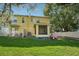 Spacious backyard with lush green grass, mature trees, and a screened lanai, perfect for outdoor living at 5302 Aloha Seed Dr, Seffner, FL 33584
