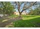 Lush backyard with mature trees, providing shade and privacy at 5302 Aloha Seed Dr, Seffner, FL 33584
