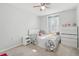This bedroom includes a ceiling fan, simple decor, a bright window, and a dresser at 5302 Aloha Seed Dr, Seffner, FL 33584