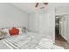 Bedroom featuring neutral walls, ceiling fan, two large windows, and a full-size bed with accent pillows at 5302 Aloha Seed Dr, Seffner, FL 33584