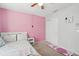 This cozy bedroom includes a ceiling fan, simple decor, and closet access at 5302 Aloha Seed Dr, Seffner, FL 33584