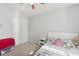 Bright bedroom features a ceiling fan, plush carpet, and closet for storage at 5302 Aloha Seed Dr, Seffner, FL 33584