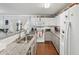 Bright kitchen with white cabinets, stainless steel appliances, granite countertops, and a stainless steel sink at 5302 Aloha Seed Dr, Seffner, FL 33584