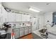 Bright kitchen with white cabinets, stainless steel appliances, granite countertops, and a stainless steel sink at 5302 Aloha Seed Dr, Seffner, FL 33584