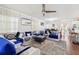 View of the living room with fan and decorative couch, including dining room in background at 5302 Aloha Seed Dr, Seffner, FL 33584