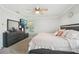 This main bedroom features a mirrored dresser, TV, ceiling fan, and plush rugs at 5302 Aloha Seed Dr, Seffner, FL 33584
