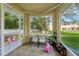 Relaxing sunroom with tile flooring, large windows, and views of the backyard at 5302 Aloha Seed Dr, Seffner, FL 33584
