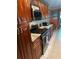Well-lit kitchen features granite countertops, tiled backsplash, stainless steel appliances, and wooden cabinets at 6190 80Th N St # 204, St Petersburg, FL 33709