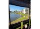Scenic view of lake and community buildings from the condo's screened-in lanai at 6190 80Th N St # 204, St Petersburg, FL 33709