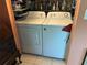 Neat laundry area featuring an Amana washer and dryer set and plenty of overhead shelving for storage at 6190 80Th N St # 204, St Petersburg, FL 33709
