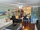 Inviting living area featuring hardwood floors, stylish decor, and an open floor plan leading to the dining area at 6190 80Th N St # 204, St Petersburg, FL 33709