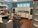 Crafting room or office space featuring desk, storage and shelving, and hardwood flooring with a ceiling fan at 6190 80Th N St # 204, St Petersburg, FL 33709