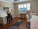 Bright office space featuring two desks, beach artwork, and a ceiling fan at 6190 80Th N St # 204, St Petersburg, FL 33709