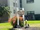 Sign with manicured landscaping and palm tree at 6190 80Th N St # 204, St Petersburg, FL 33709
