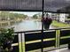 Relaxing water view from the balcony, enhanced with colorful potted plants, offering a serene outdoor living space at 6190 80Th N St # 204, St Petersburg, FL 33709