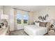 Bright bedroom with a comfortable bed, stylish décor, and large windows offering natural light at 813 Steel Dr, Apollo Beach, FL 33572