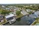 Aerial view of a waterfront home with pool, dock, boat, and lush landscaping at 8721 Bay Crest Ln, Tampa, FL 33615