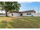 Exterior of home showing the backyard with doors and windows and spacious lawn area at 8721 Bay Crest Ln, Tampa, FL 33615