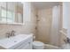 This bathroom features tiled walls, a shower, toilet, sink, and vanity at 8721 Bay Crest Ln, Tampa, FL 33615