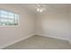 Neutral bedroom with a ceiling fan and a window that has a view of the outdoors at 8721 Bay Crest Ln, Tampa, FL 33615