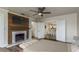 This bedroom features a fireplace, a ceiling fan, and an open view to the kitchen at 8721 Bay Crest Ln, Tampa, FL 33615