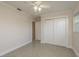 This bedroom features neutral walls, ceiling fan, an entrance to another room and closet at 8721 Bay Crest Ln, Tampa, FL 33615