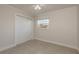 Bright bedroom with neutral walls, ceiling fan, a window, and closet at 8721 Bay Crest Ln, Tampa, FL 33615