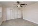 This bedroom features neutral walls, ceiling fan, an entrance to another room and closet at 8721 Bay Crest Ln, Tampa, FL 33615