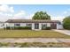Charming single-story home with a well-manicured lawn, clean design, and a two-car garage at 8721 Bay Crest Ln, Tampa, FL 33615