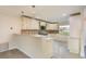 Bright kitchen featuring white cabinets, granite countertops, and stainless steel appliances at 8721 Bay Crest Ln, Tampa, FL 33615