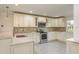 Bright kitchen featuring white cabinets, granite countertops, and stainless steel appliances at 8721 Bay Crest Ln, Tampa, FL 33615
