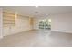 Spacious living room with lots of natural light and built-in shelving at 8721 Bay Crest Ln, Tampa, FL 33615