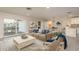 Bright living room with modern decor, and access to a waterfront patio area, perfect for relaxing and entertaining at 8721 Bay Crest Ln, Tampa, FL 33615