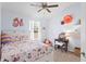 Light-filled bedroom features a whimsical decor, a comfortable bed, and charming decorative accents at 9534 W Park Village Dr, Tampa, FL 33626