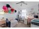 Well-lit room with charming decor, including a cozy blue chair, desk, and decorative wall flowers at 9534 W Park Village Dr, Tampa, FL 33626